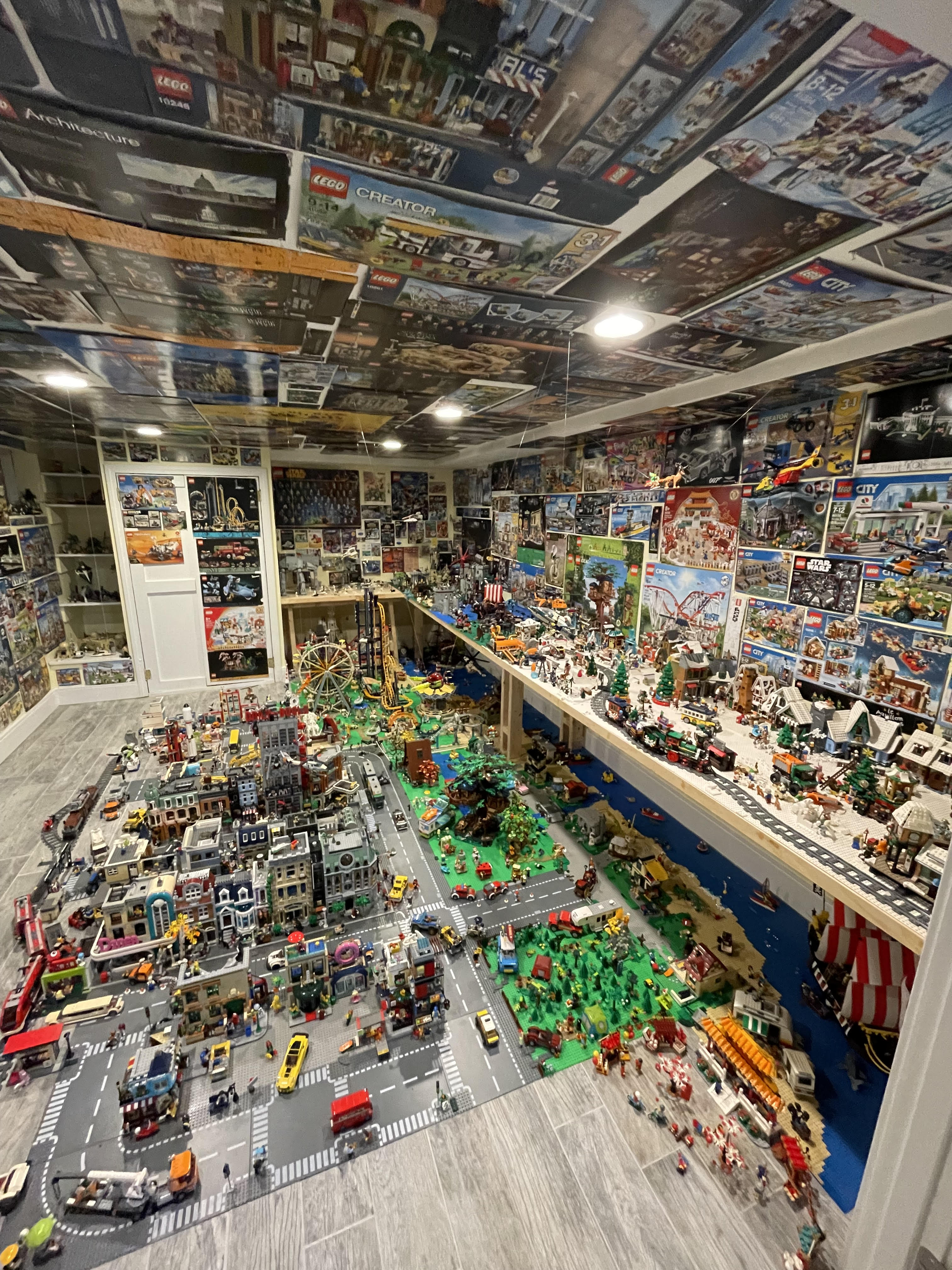 Room with lego boxes on the walls and ceiling and legos all over